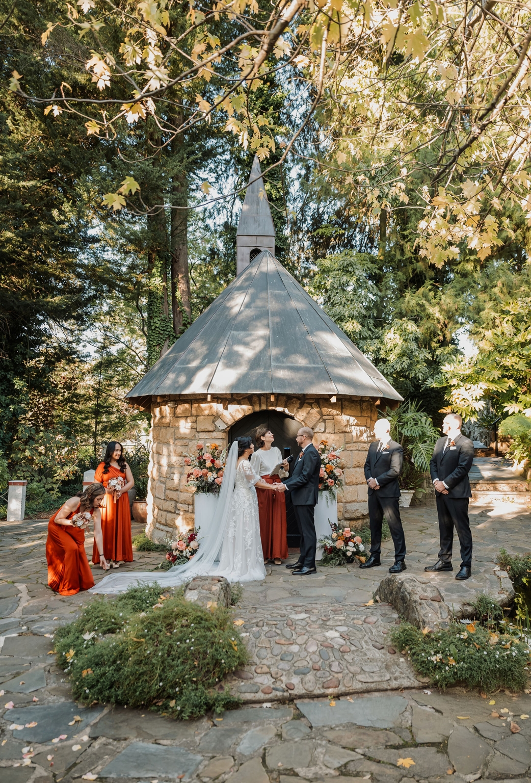 adelaide hills wedding at the manor - jo & dan 21 Rustic garden chapel wedding ceremony with bride, groom, and autumn floral decor.