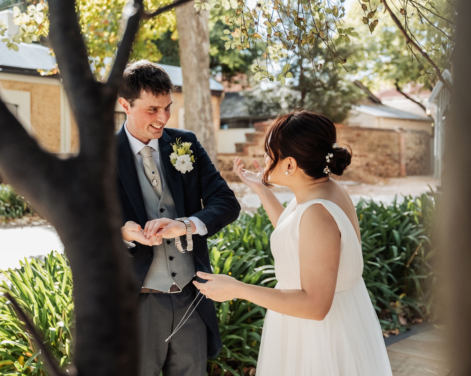 adelaide's st peter's cathedral wedding - irish & nick 8 Bride and groom share a joyful garden wedding moment outdoors.