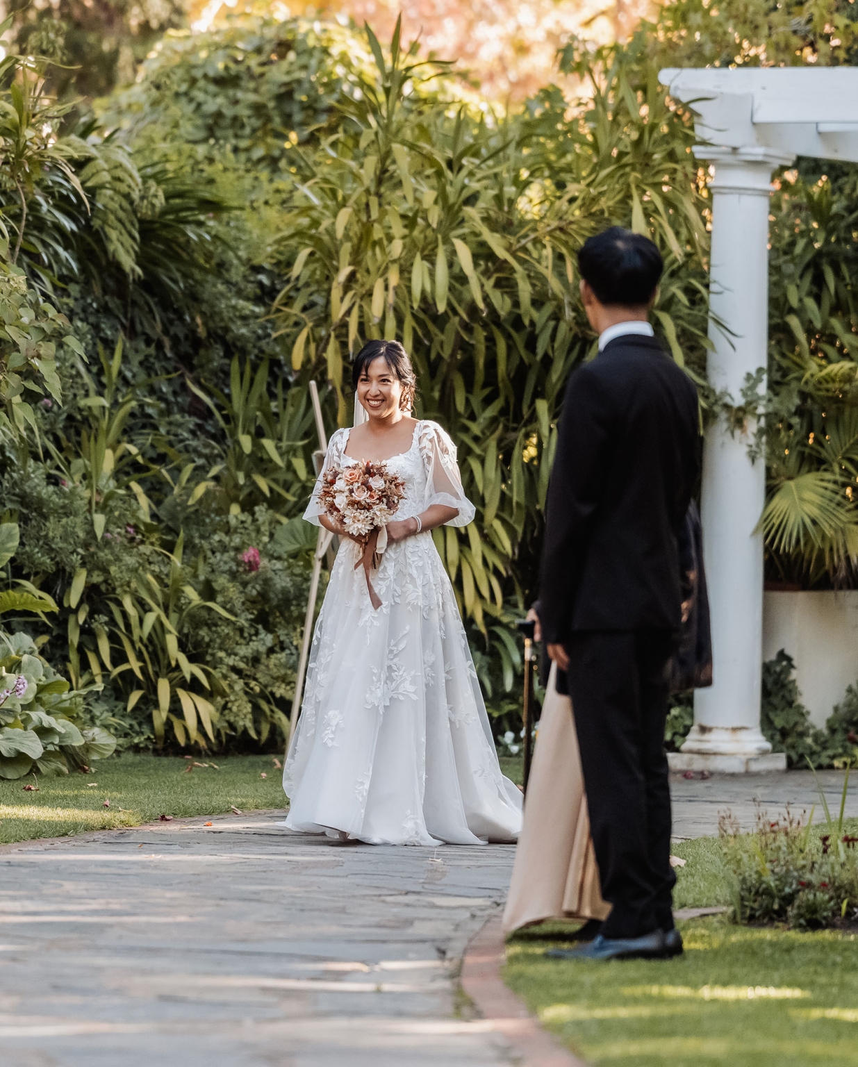 adelaide hills wedding at the manor - jo & dan 18 Garden wedding first look with bride in embroidered gown and groom.