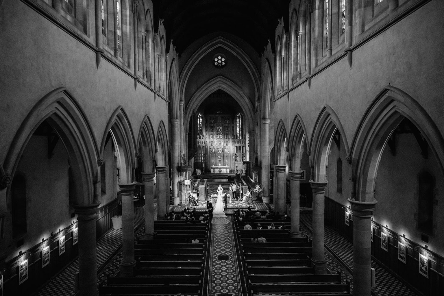 adelaide's st peter's cathedral wedding - irish & nick 17 Black and white Gothic church wedding ceremony with bride in grand cathedral nave.