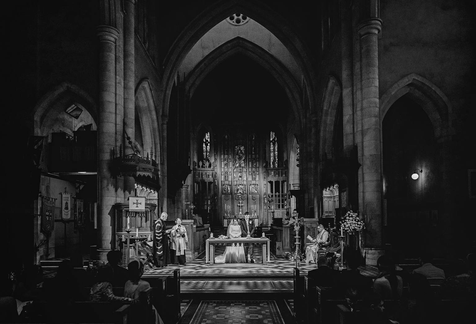 adelaide's st peter's cathedral wedding - irish & nick 26 Gothic church wedding ceremony with bride and groom at the altar.