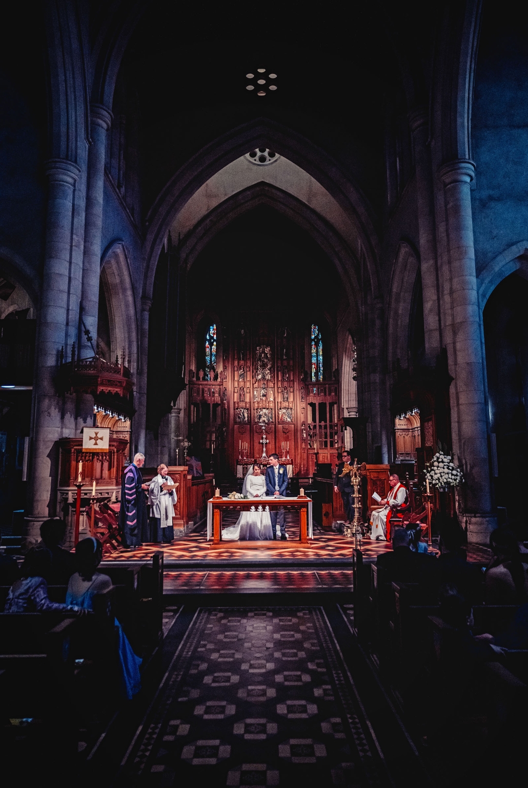 adelaide's st peter's cathedral wedding - irish & nick 27 Gothic church wedding ceremony with bride and groom at candlelit altar.