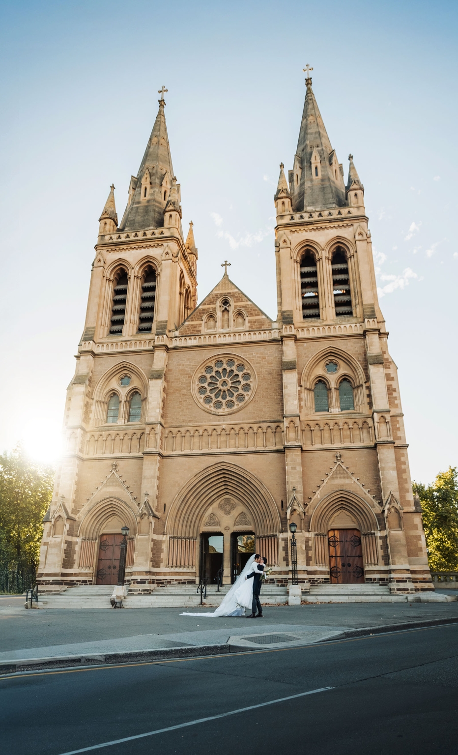 adelaide's st peter's cathedral wedding - irish & nick 34 Gothic church wedding couple kissing outside historic cathedral.