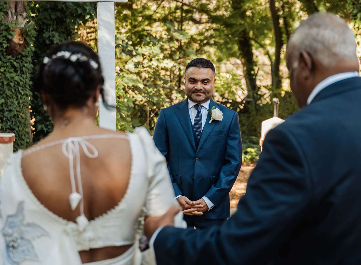 manor wedding in basket range - methmini & aravinda 134 Serene garden wedding with bride, groom, and family, showcasing elegance and anticipation.