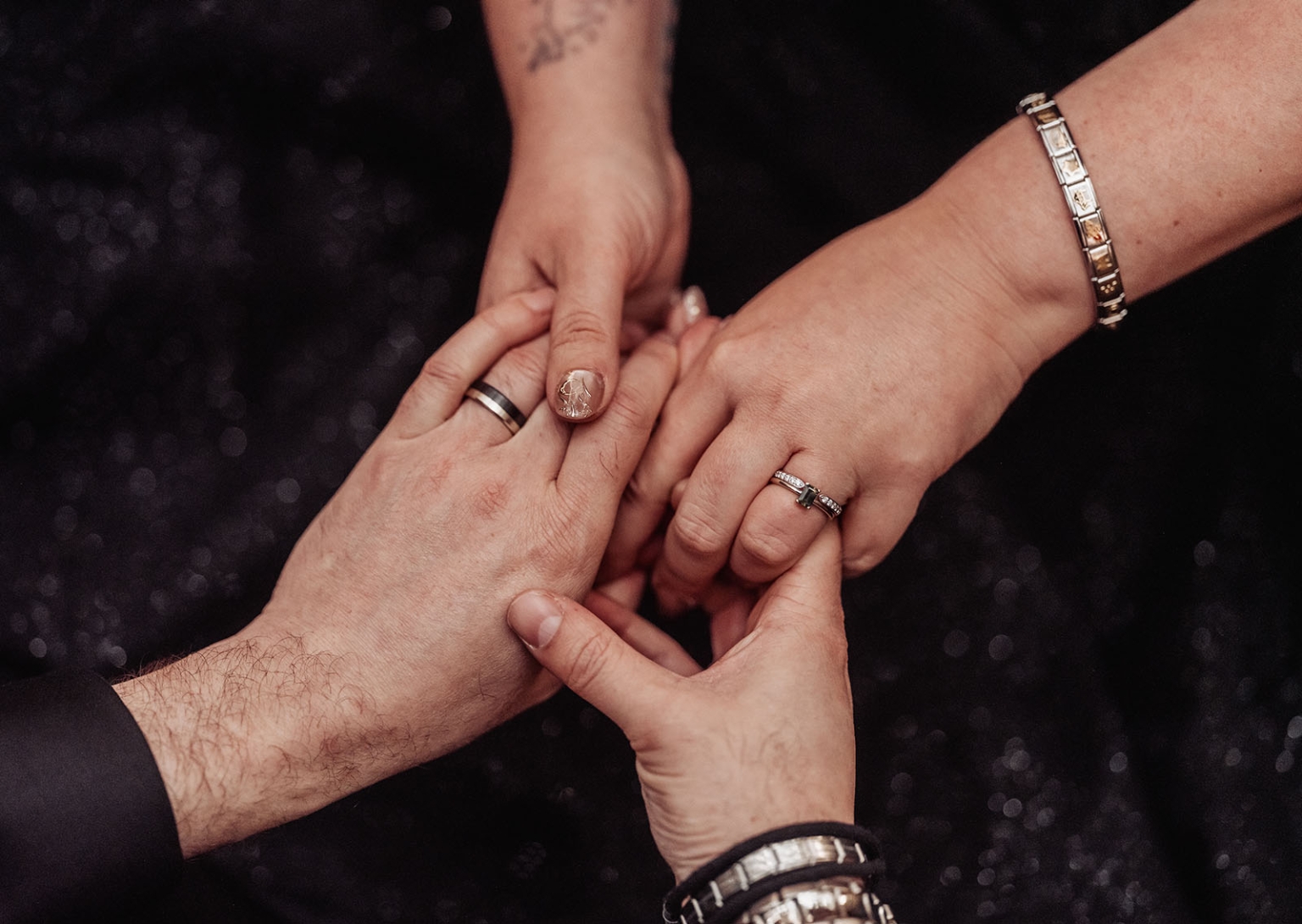 kuitpo forest metal themed wedding – erin & michael 16 Hands with wedding rings joined during intimate commitment ceremony.