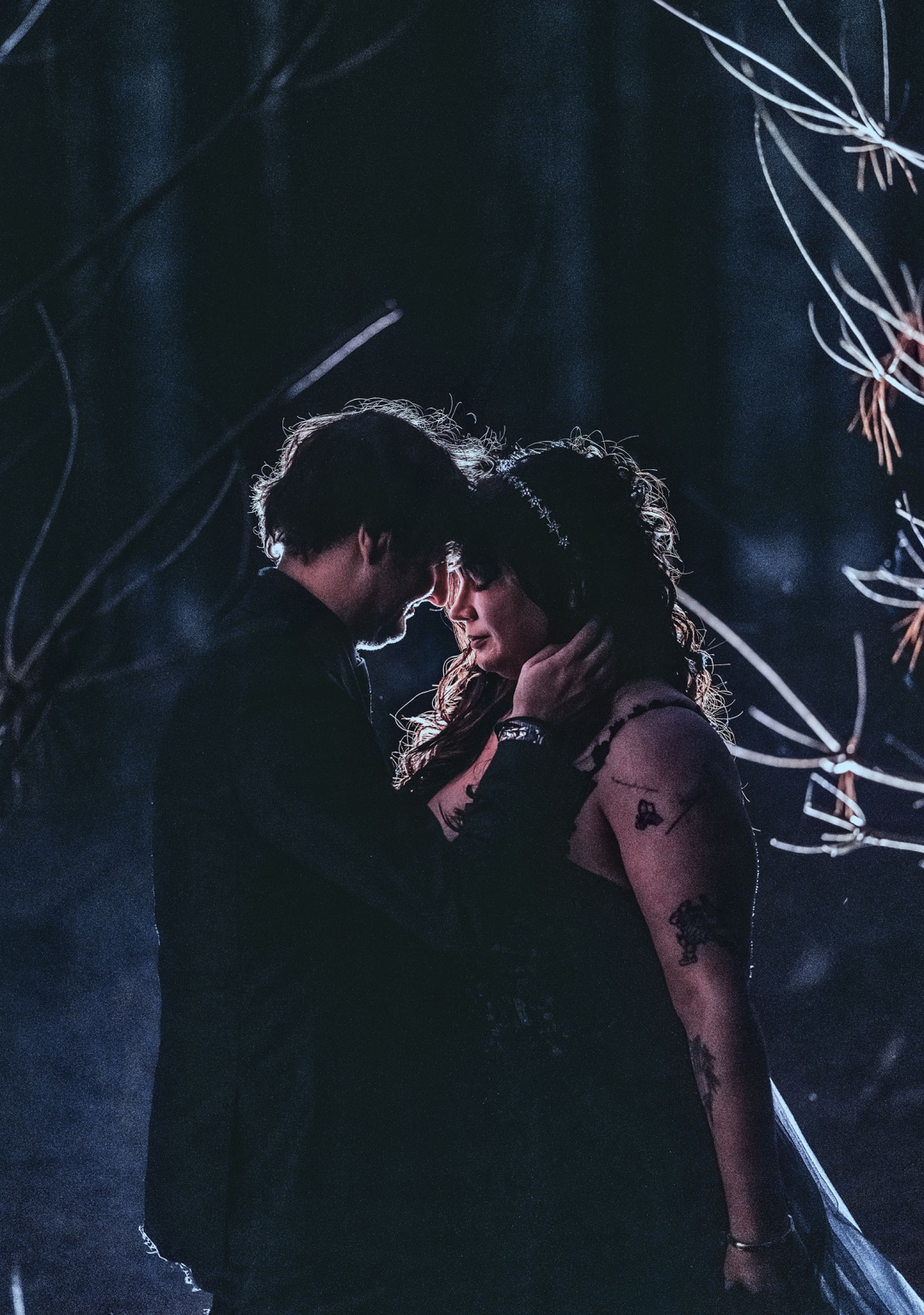 kuitpo forest metal themed wedding – erin & michael 33 Romantic cinematic portrait of an intimate couple touching foreheads in dramatic low light.