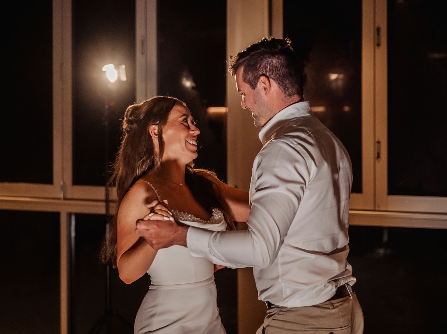 the lane vineyard wedding - caitlyn & craig 137 Couple dancing romantically at a wedding, bathed in soft light, expressing love and joy.