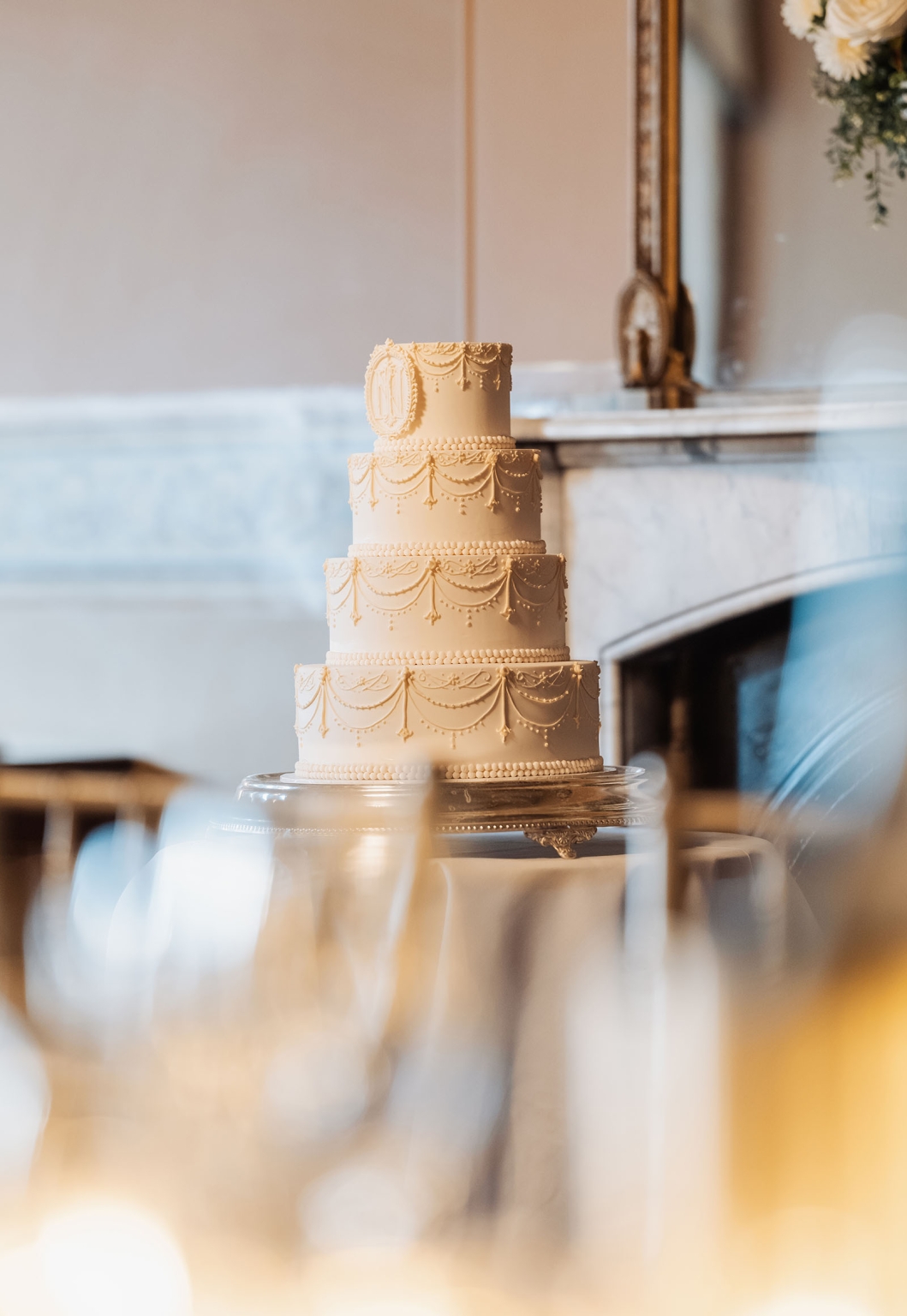 adelaide's st peter's cathedral wedding - irish & nick 52 Ivory four-tier wedding cake with ornate piping in an elegant reception venue.