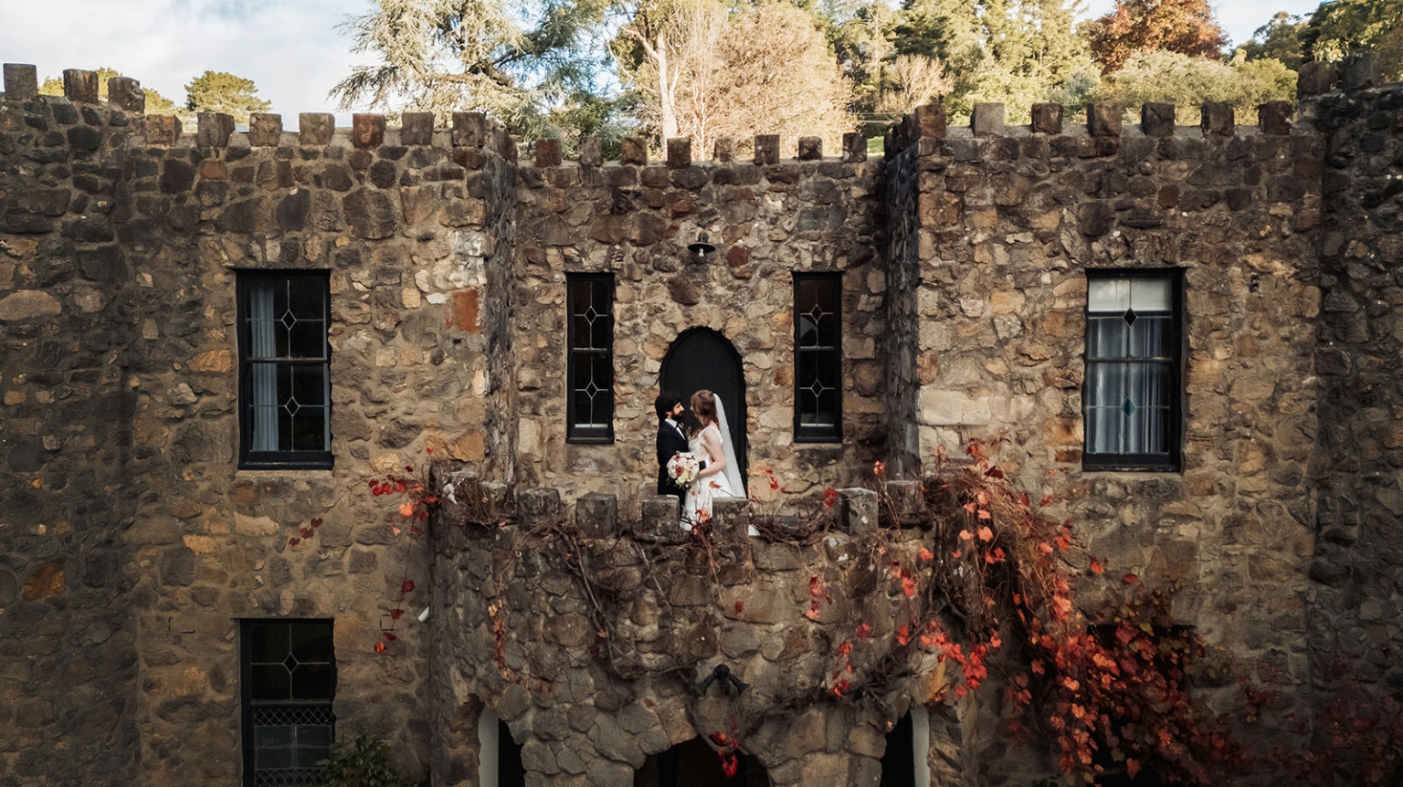beautiful manor basket range wedding - sophie & theodore 129 Romantic medieval wedding scene with autumn foliage in front of a castle.