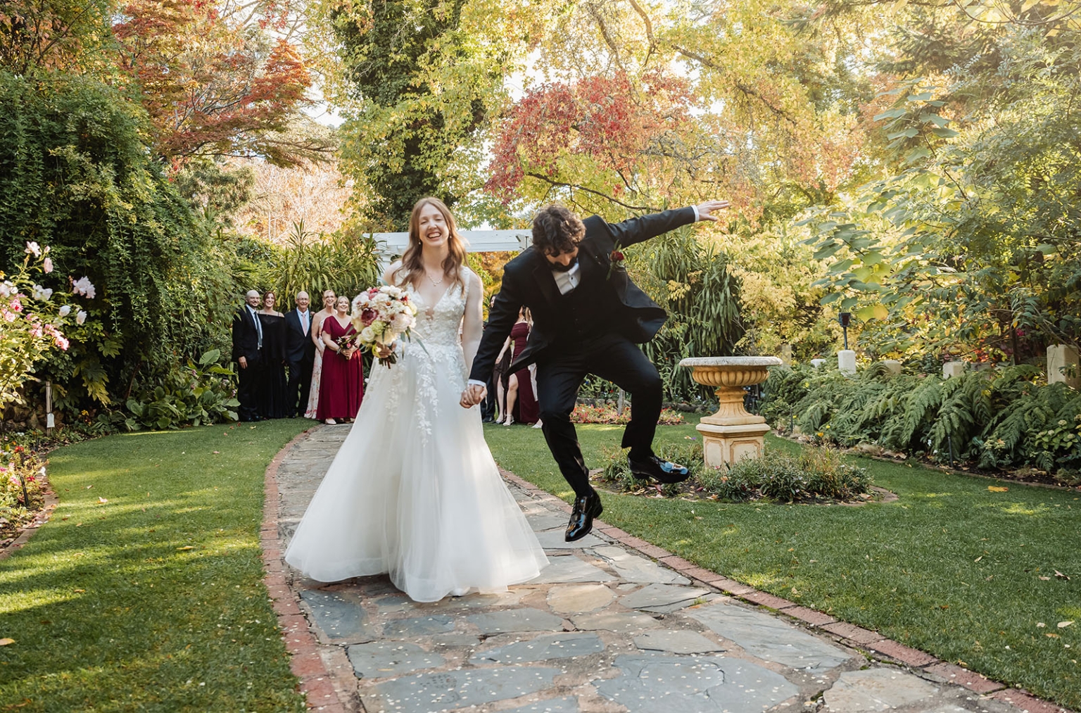 beautiful manor basket range wedding - sophie & theodore 111 Joyful outdoor wedding with bride, groom, vibrant foliage, and festive wedding party.