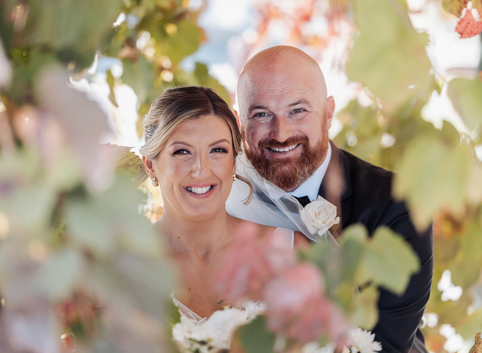 lloyd brothers wedding - dajana & tom 30 Joyful newlyweds surrounded by lush greenery on their wedding day.