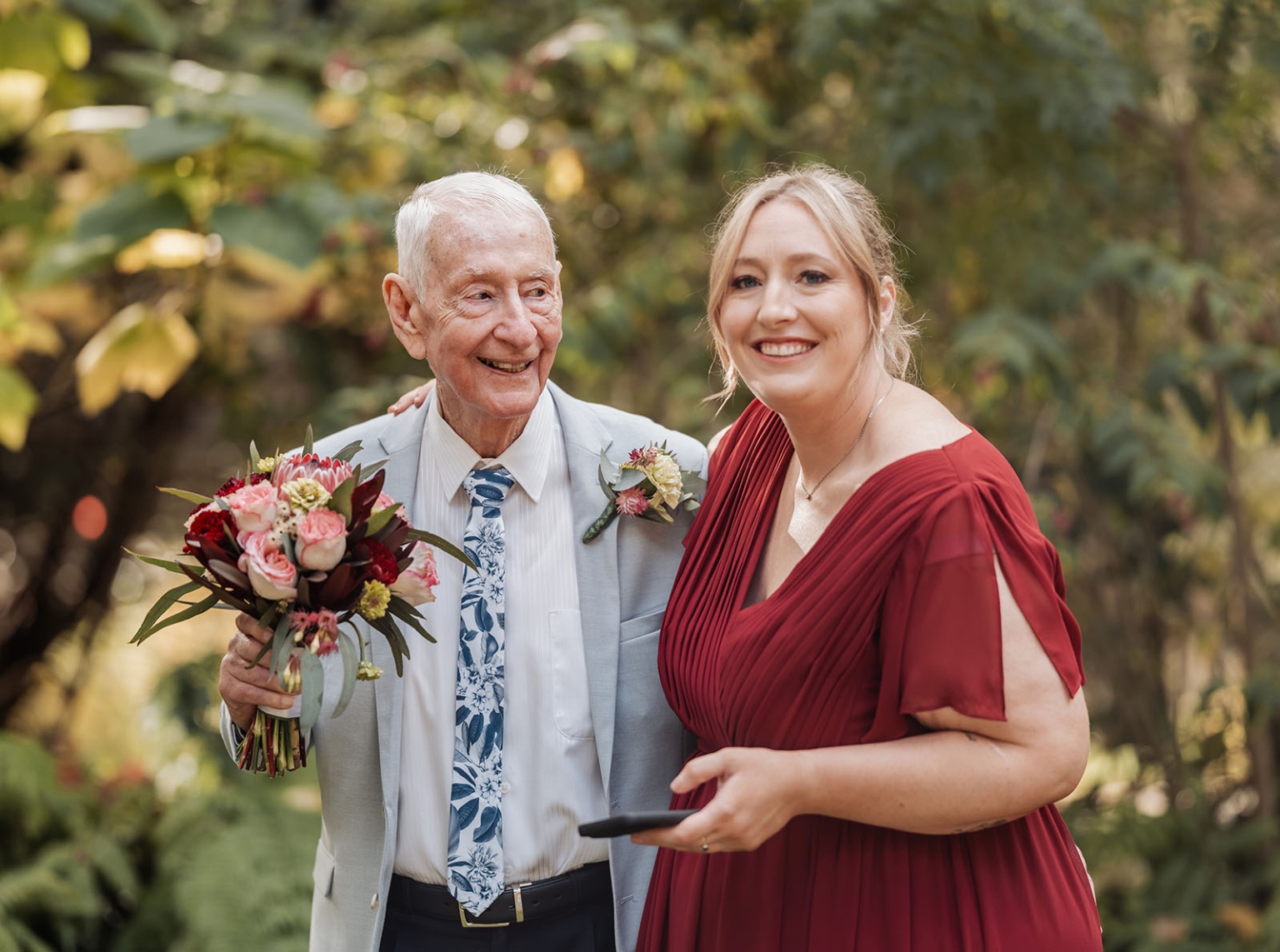 beautiful manor basket range wedding - sophie & theodore 110 Elderly man and woman sharing joyful moment in garden with flowers and smiles.