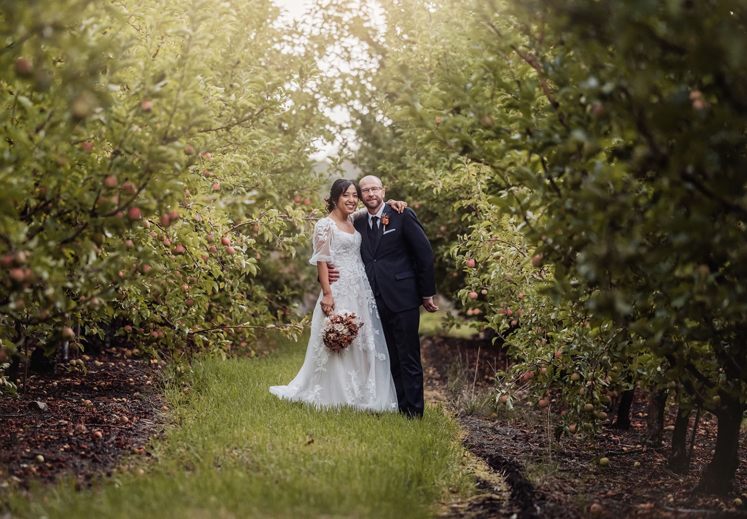 adelaide hills wedding at the manor - jo & dan 52 Bride and groom in elegant orchard wedding among apple trees.
