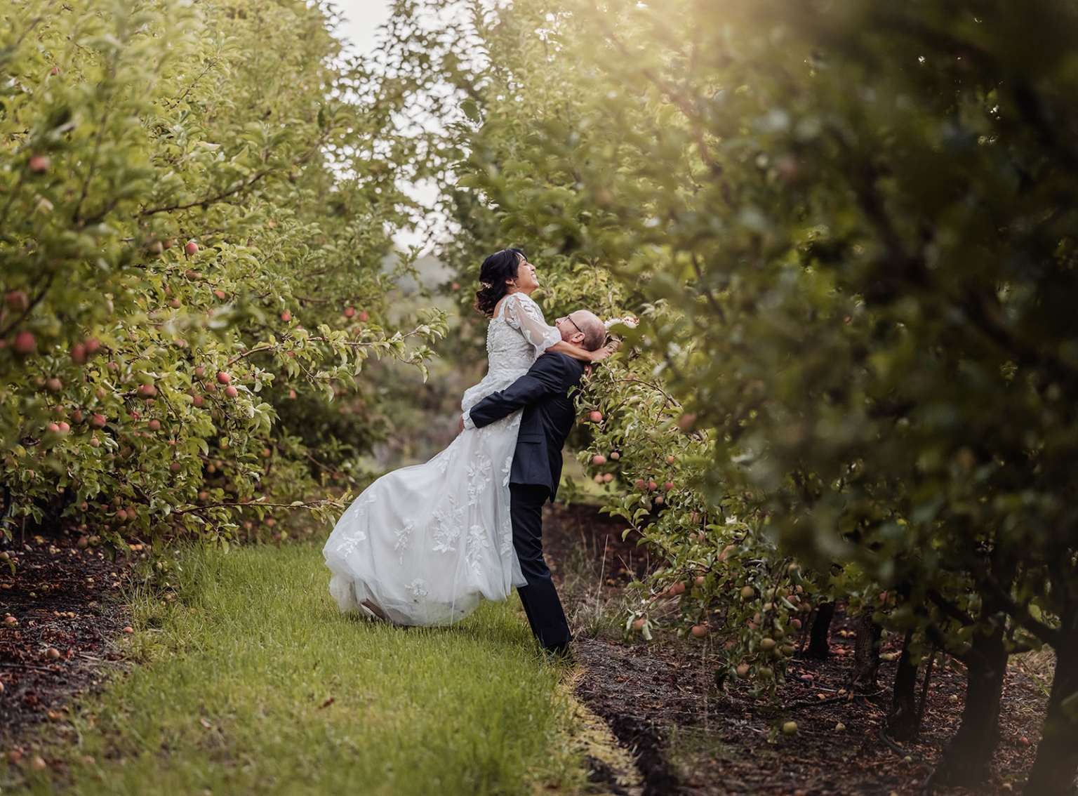adelaide hills wedding at the manor - jo & dan 51 Romantic bride and groom wedding portrait in a lush apple orchard.