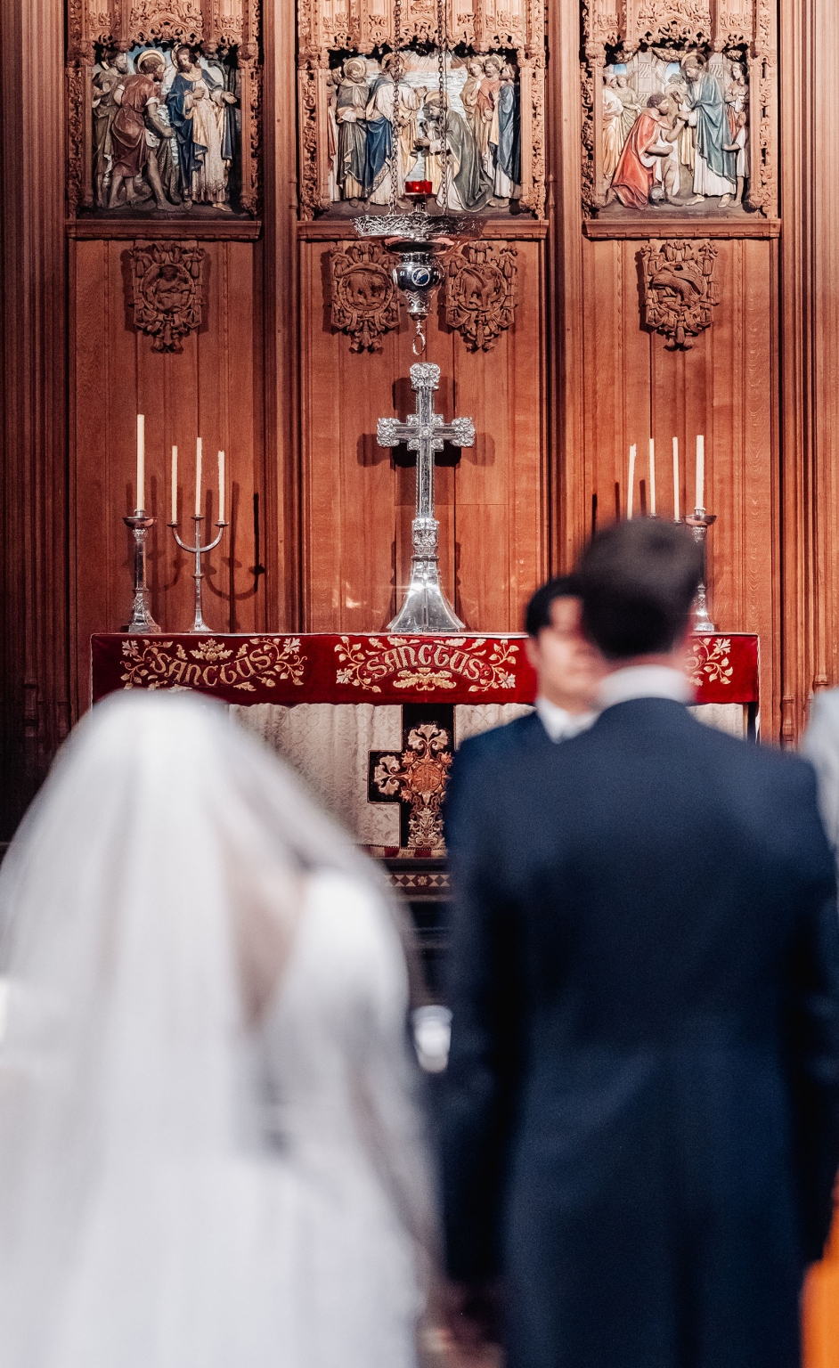 adelaide's st peter's cathedral wedding - irish & nick 18 Ornate church altar with silver cross, candles, and wedding ceremony.