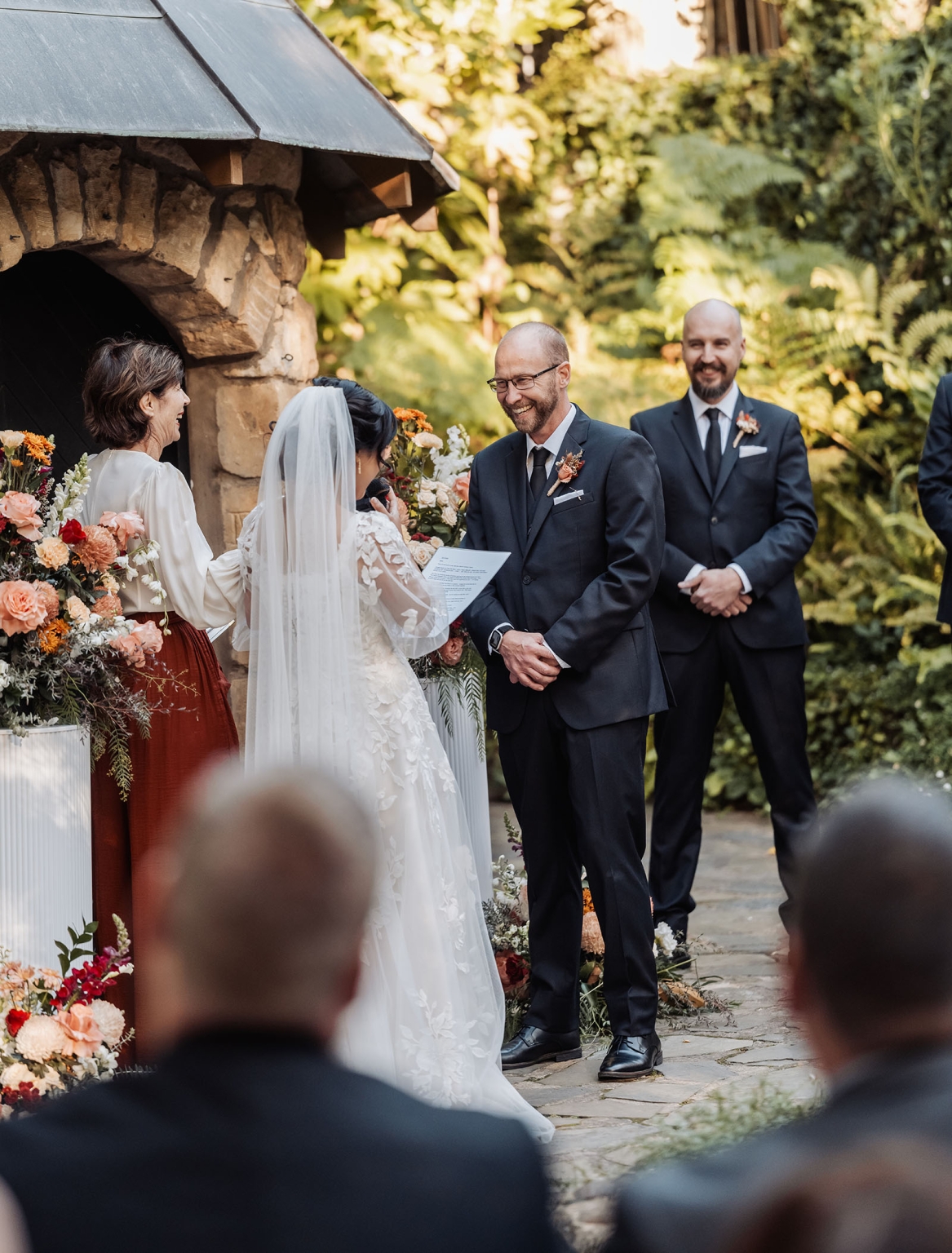 adelaide hills wedding at the manor - jo & dan 24 Outdoor garden wedding ceremony with bride reading vows to smiling groom.