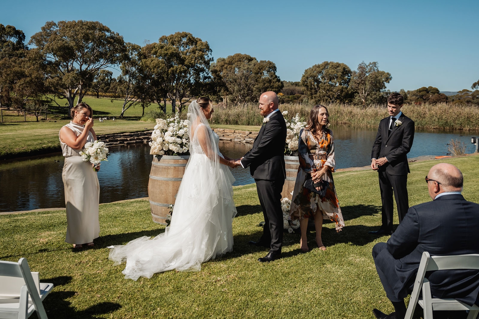 lloyd brothers wedding - dajana & tom 11 Outdoor wedding with bride, groom, rustic decor, picturesque landscape, and emotional guests.