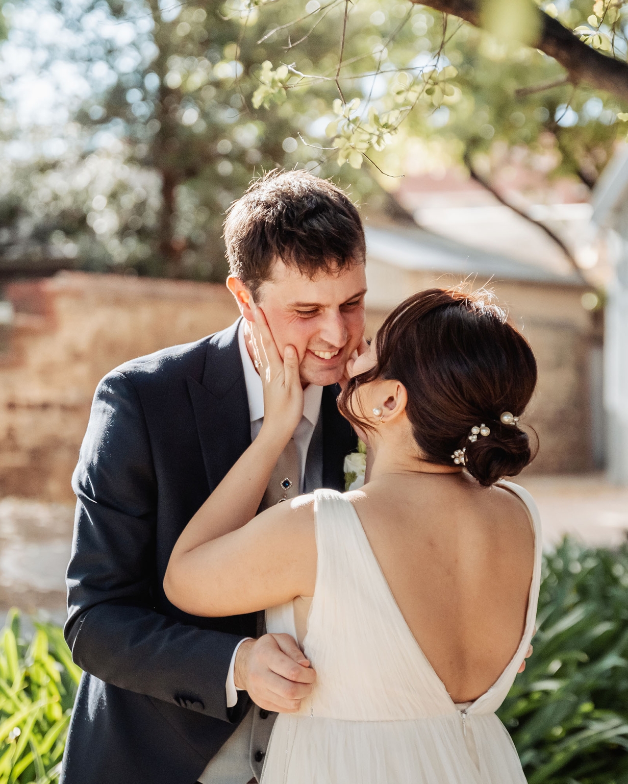 adelaide's st peter's cathedral wedding - irish & nick 10 Romantic outdoor wedding portrait of bride and groom sharing an intimate sunlit moment.