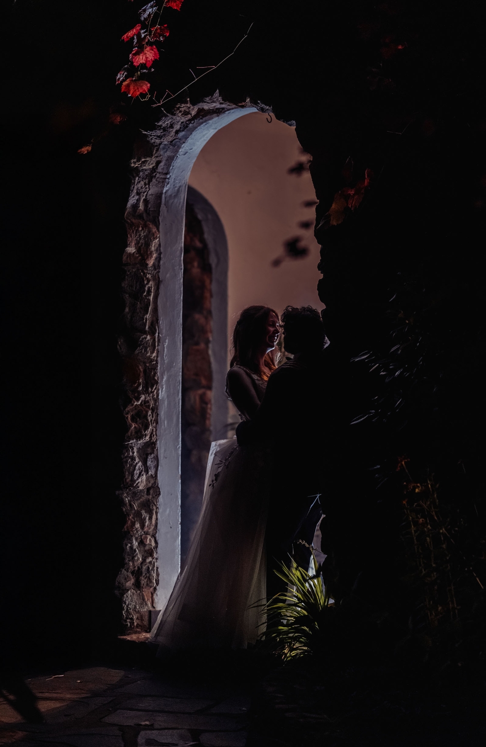 beautiful manor basket range wedding - sophie & theodore 139 Romantic silhouette in stone archway with red leaves and intimate couple embrace.