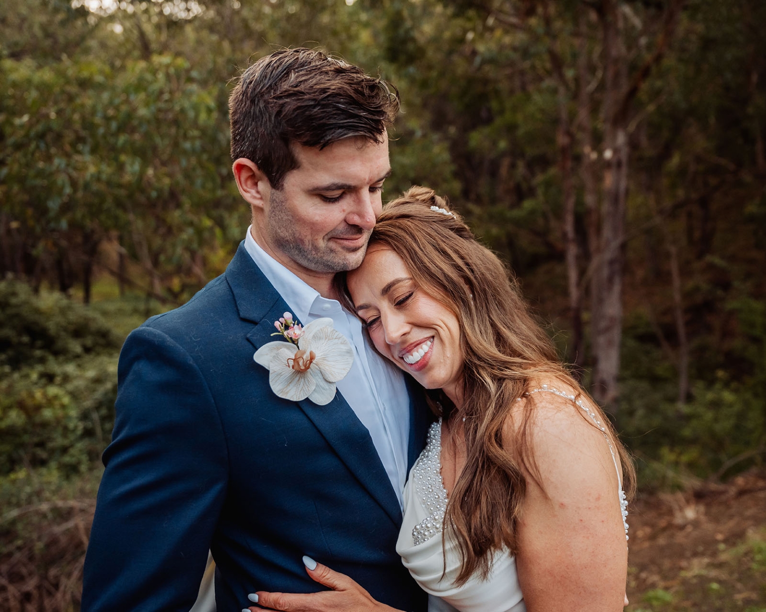 the lane vineyard wedding - caitlyn & craig 117 Bride and groom embrace tenderly in a scenic forest setting.
