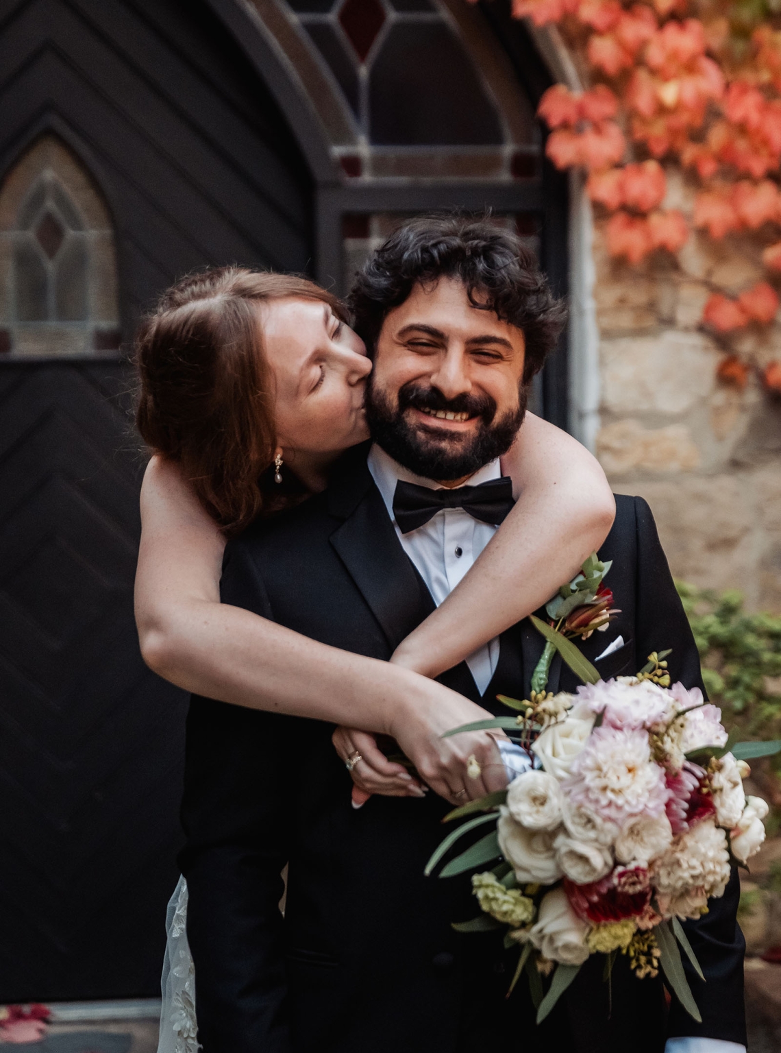 beautiful manor basket range wedding - sophie & theodore 133 Happy couple in elegant attire celebrating love with autumn backdrop and bouquet.