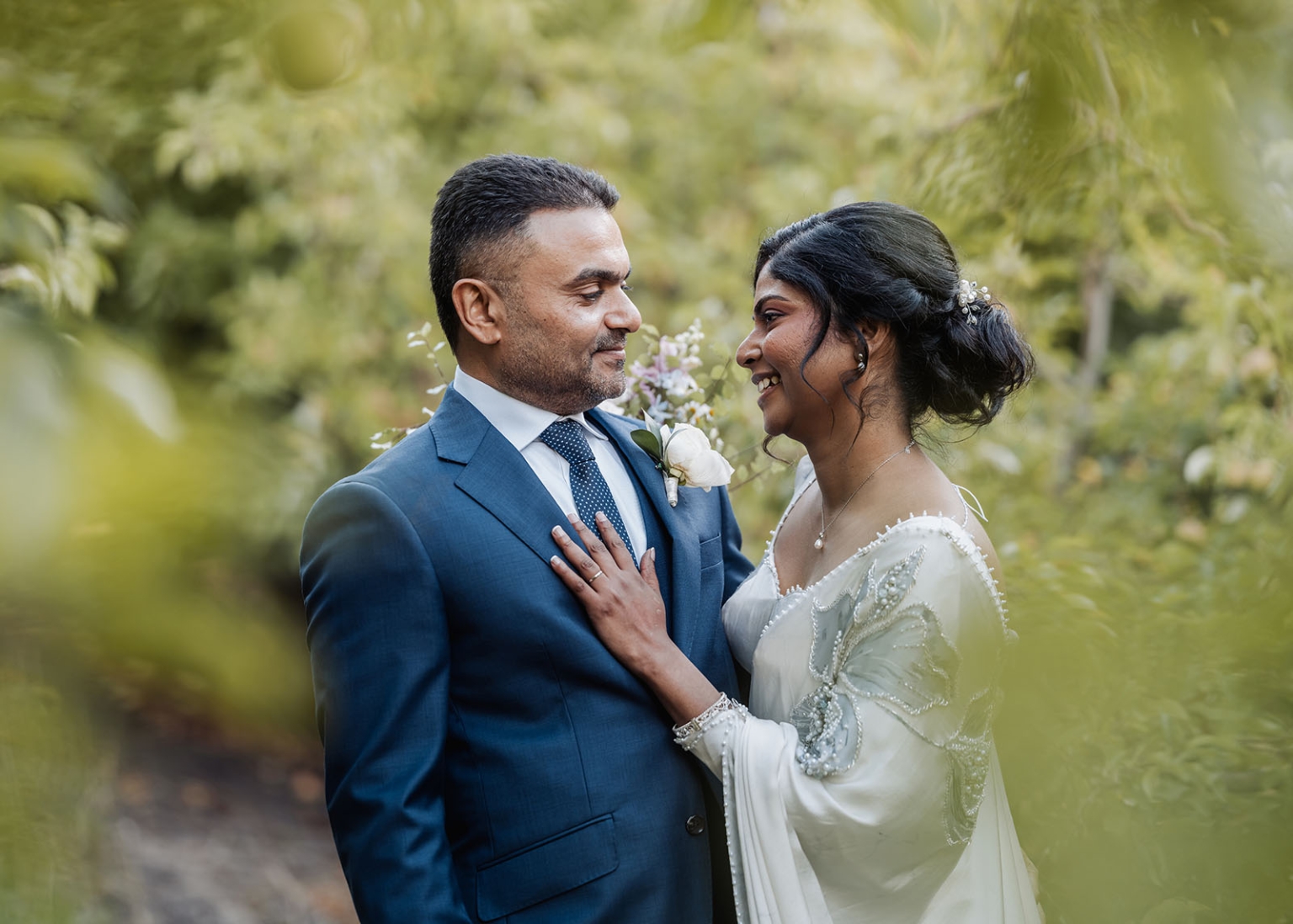 manor wedding in basket range - methmini & aravinda 154 Wedding couple in love, elegant attire, serene garden background, warm lighting.