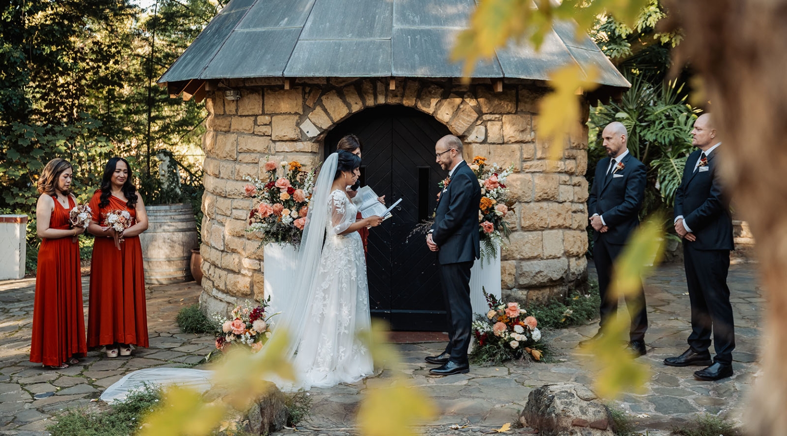 adelaide hills wedding at the manor - jo & dan 25 Rustic garden wedding ceremony with bride and groom by stone chapel and autumn flowers.