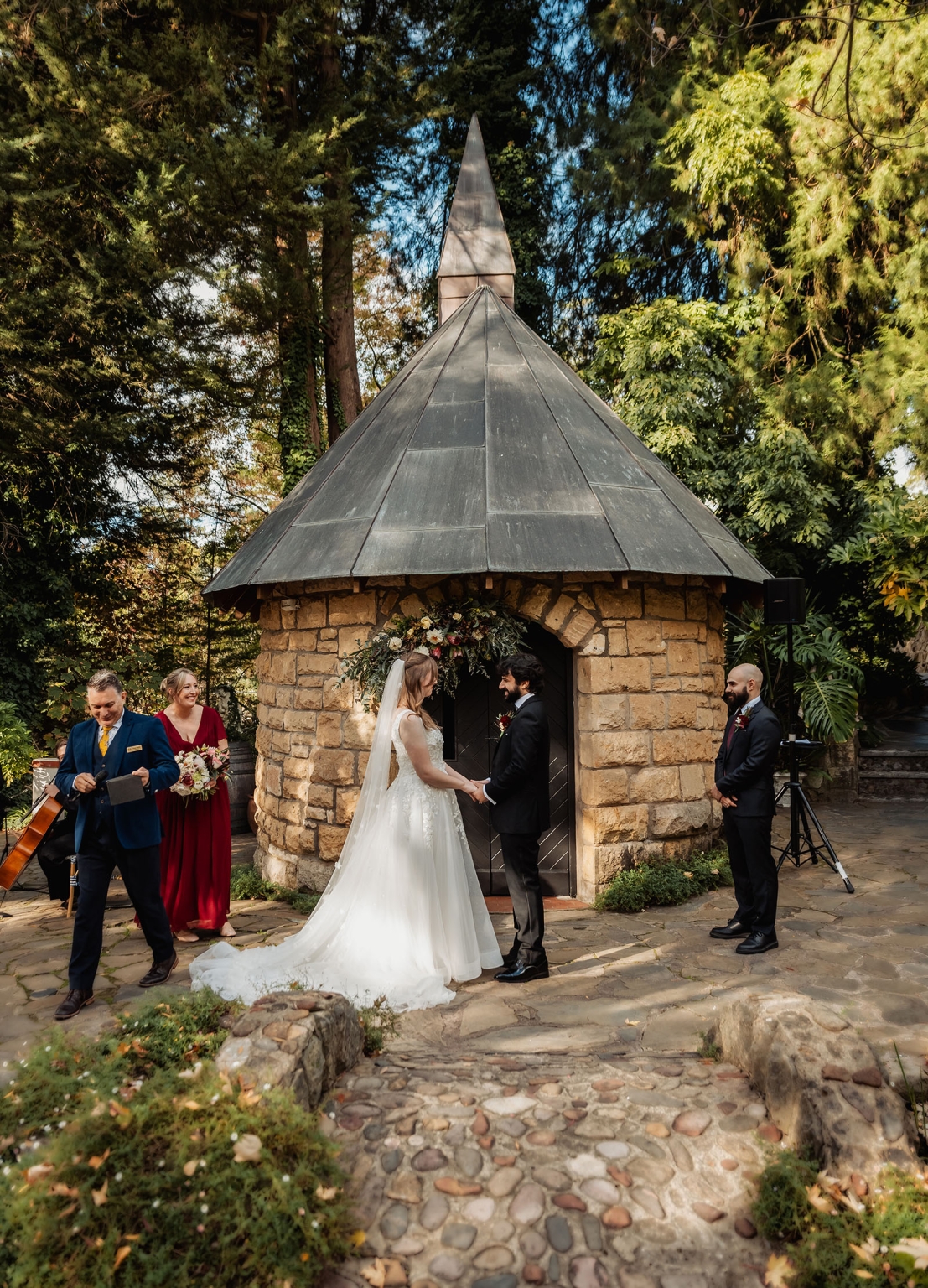 beautiful manor basket range wedding - sophie & theodore 102 Outdoor wedding ceremony with bride, groom, floral arch, and lush greenery backdrop.