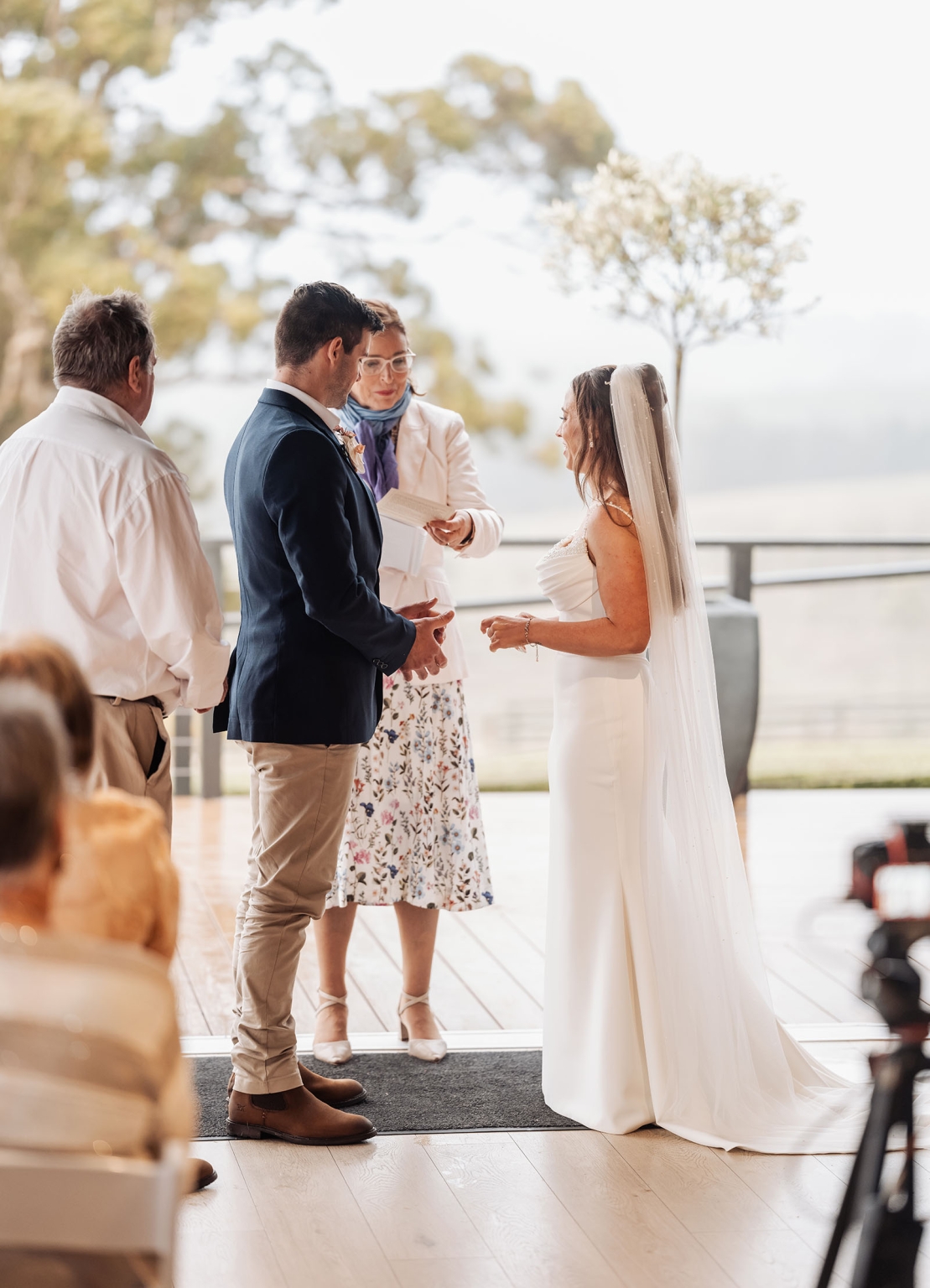 the lane vineyard wedding - caitlyn & craig 121 Outdoor wedding ceremony with bride, groom, officiant, and guests amidst serene nature backdrop.
