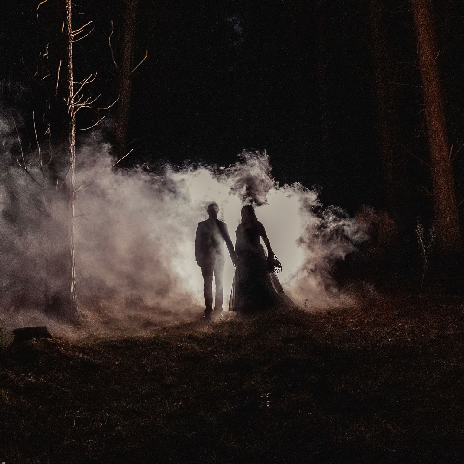kuitpo forest metal themed wedding – erin & michael 37 Silhouetted wedding couple in a foggy nighttime forest.