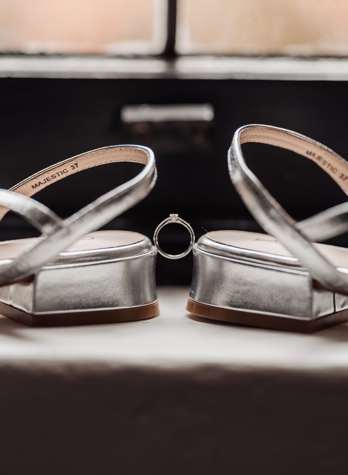 manor wedding in basket range - methmini & aravinda 106 Silver platform sandals and engagement ring on soft surface, symbolizing elegance and celebration.