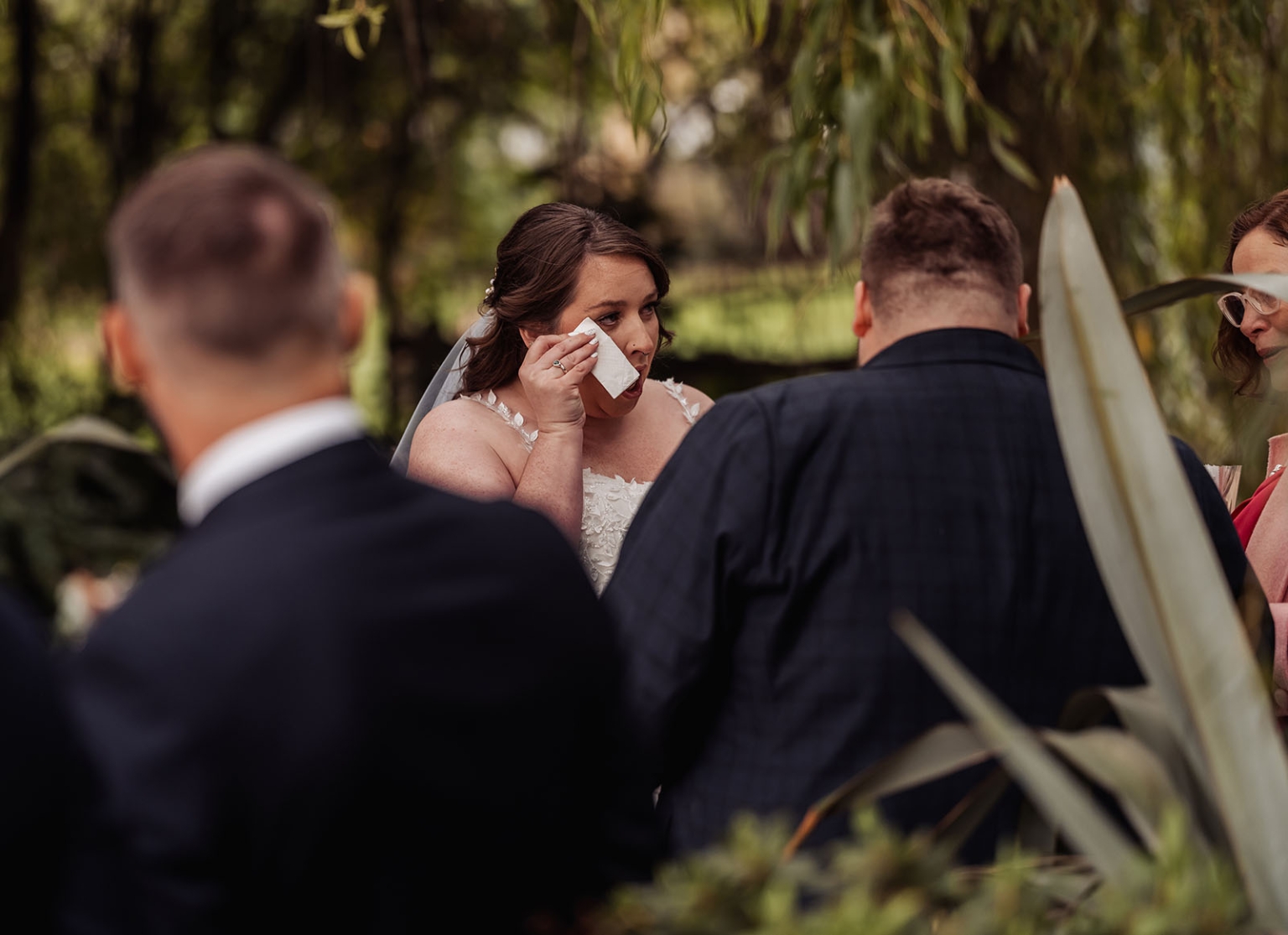 comida wedding - georgia & james 17 Bride in tears during outdoor wedding ceremony, surrounded by supportive guests in nature.