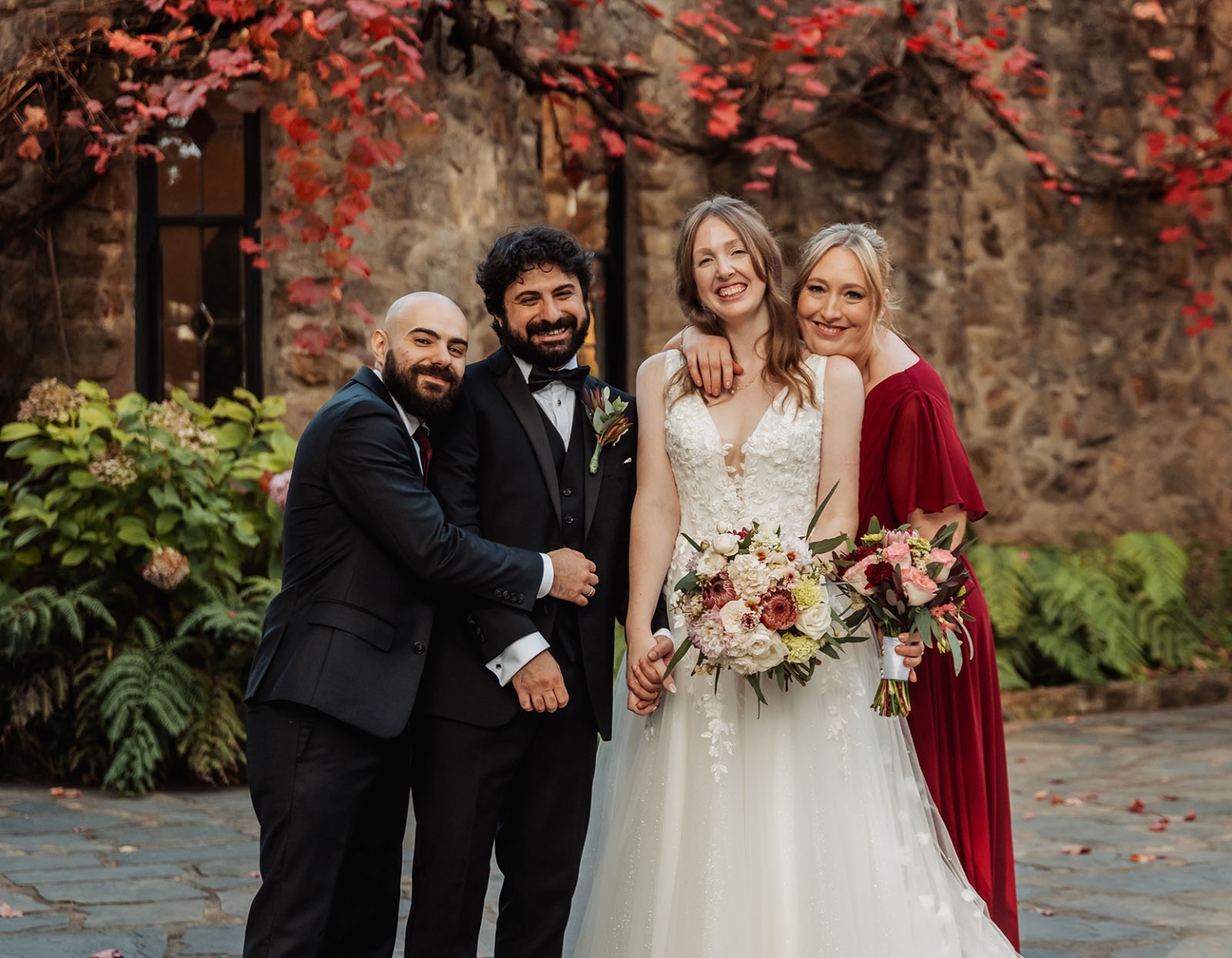 beautiful manor basket range wedding - sophie & theodore 121 Wedding party smiling in autumn setting with red foliage and elegant attire.