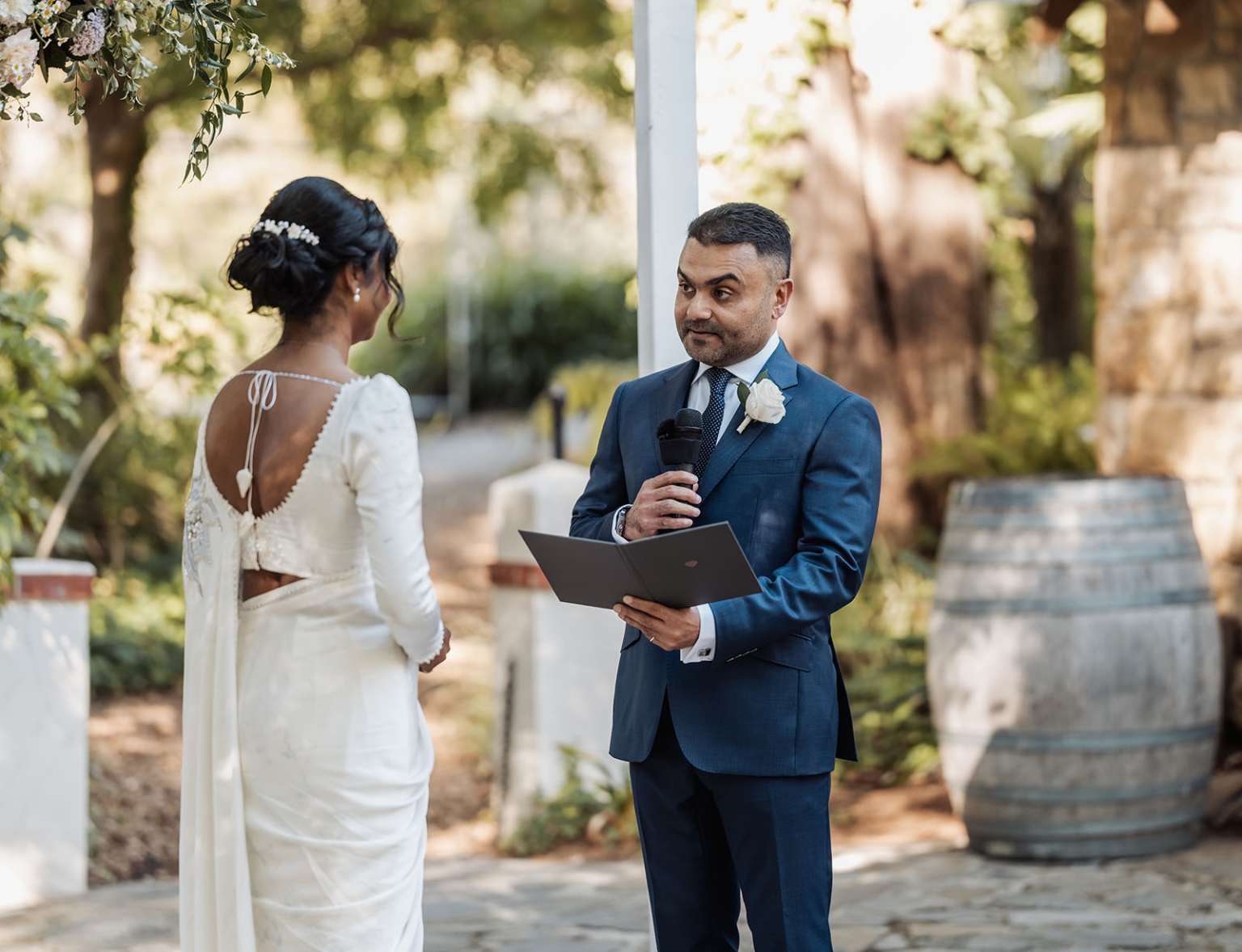manor wedding in basket range - methmini & aravinda 140 Outdoor garden wedding ceremony with bride, groom, floral arch, and rustic decor.