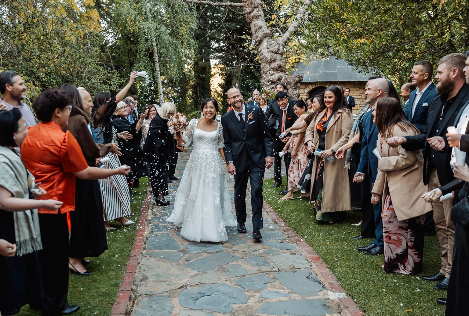adelaide hills wedding at the manor - jo & dan 31 Bride and groom enjoy a joyful garden wedding confetti exit.