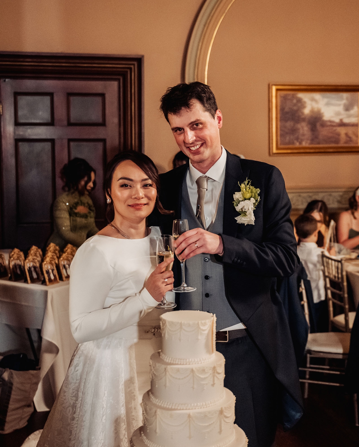 adelaide's st peter's cathedral wedding - irish & nick 60 Bride and groom toast with champagne beside elegant wedding cake at reception.