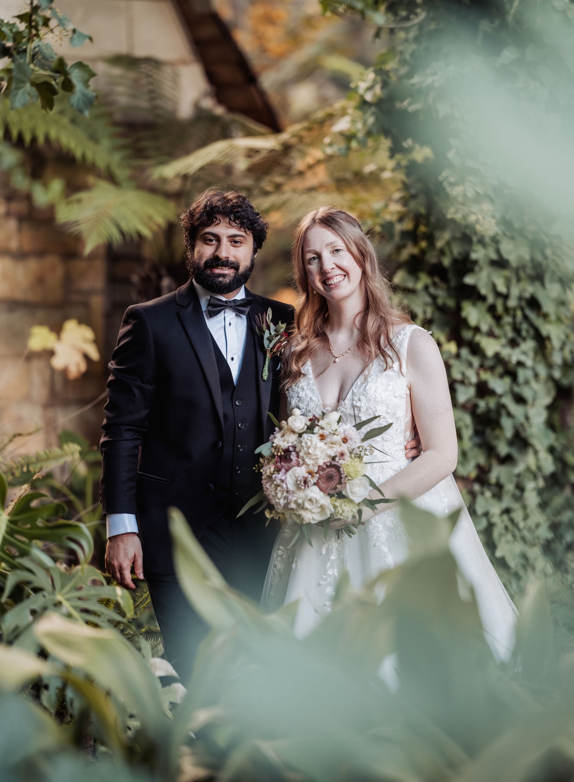 beautiful manor basket range wedding - sophie & theodore 115 Wedding couple in nature, bride in lace gown, groom in tux, lush green backdrop.