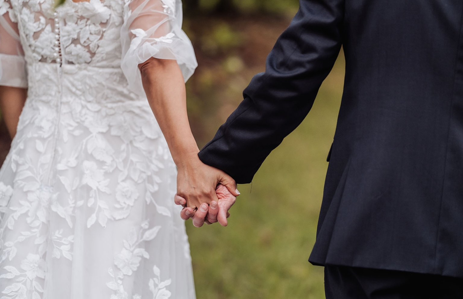 adelaide hills wedding at the manor - jo & dan 54 Bride and groom holding hands in elegant wedding attire.