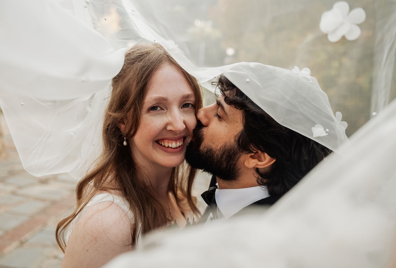 beautiful manor basket range wedding - sophie & theodore 123 Bride and groom share an intimate, joyful moment under a delicate, floral-patterned veil.