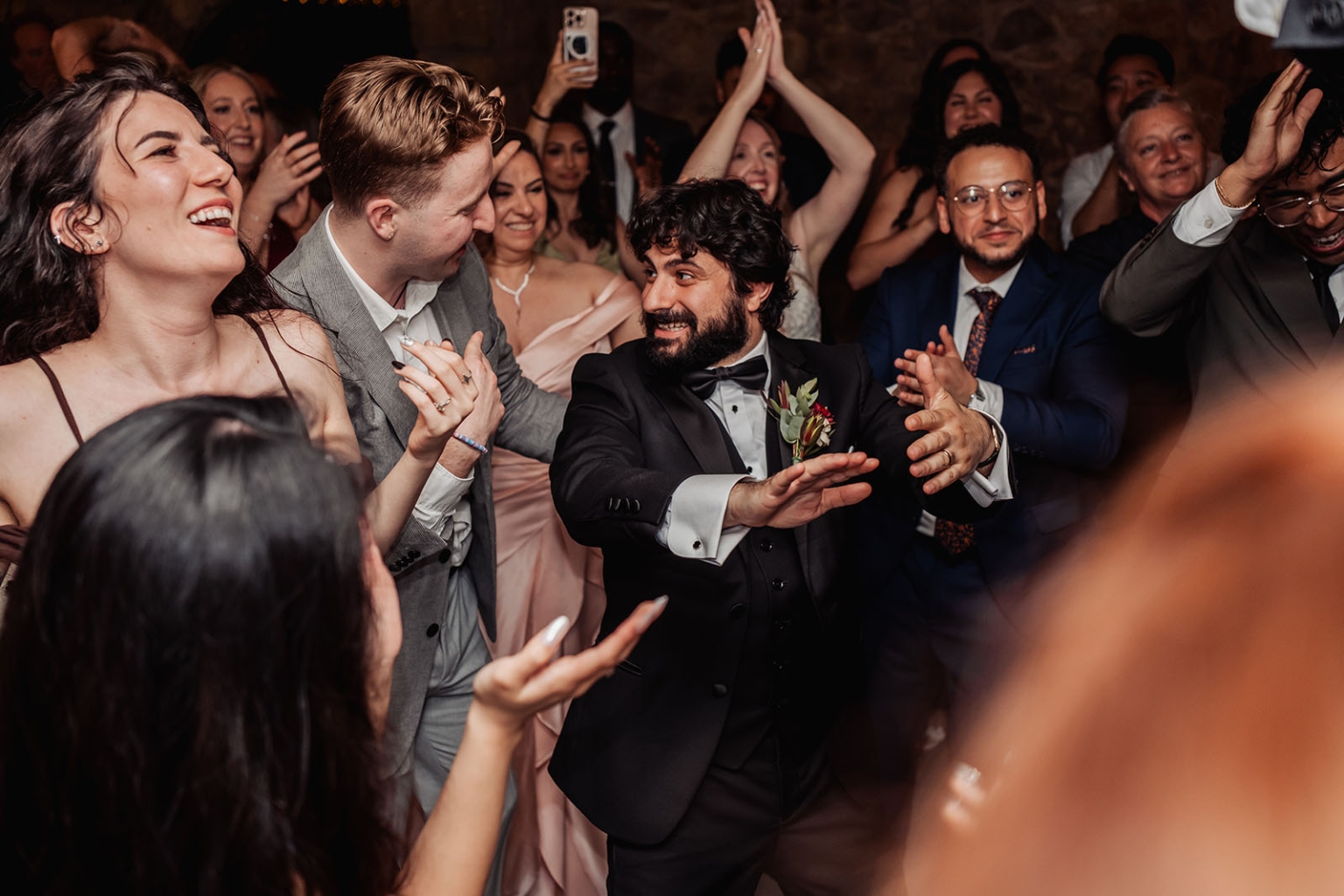 beautiful manor basket range wedding - sophie & theodore 148 Joyful wedding reception dance floor celebration with groom and guests cheering.