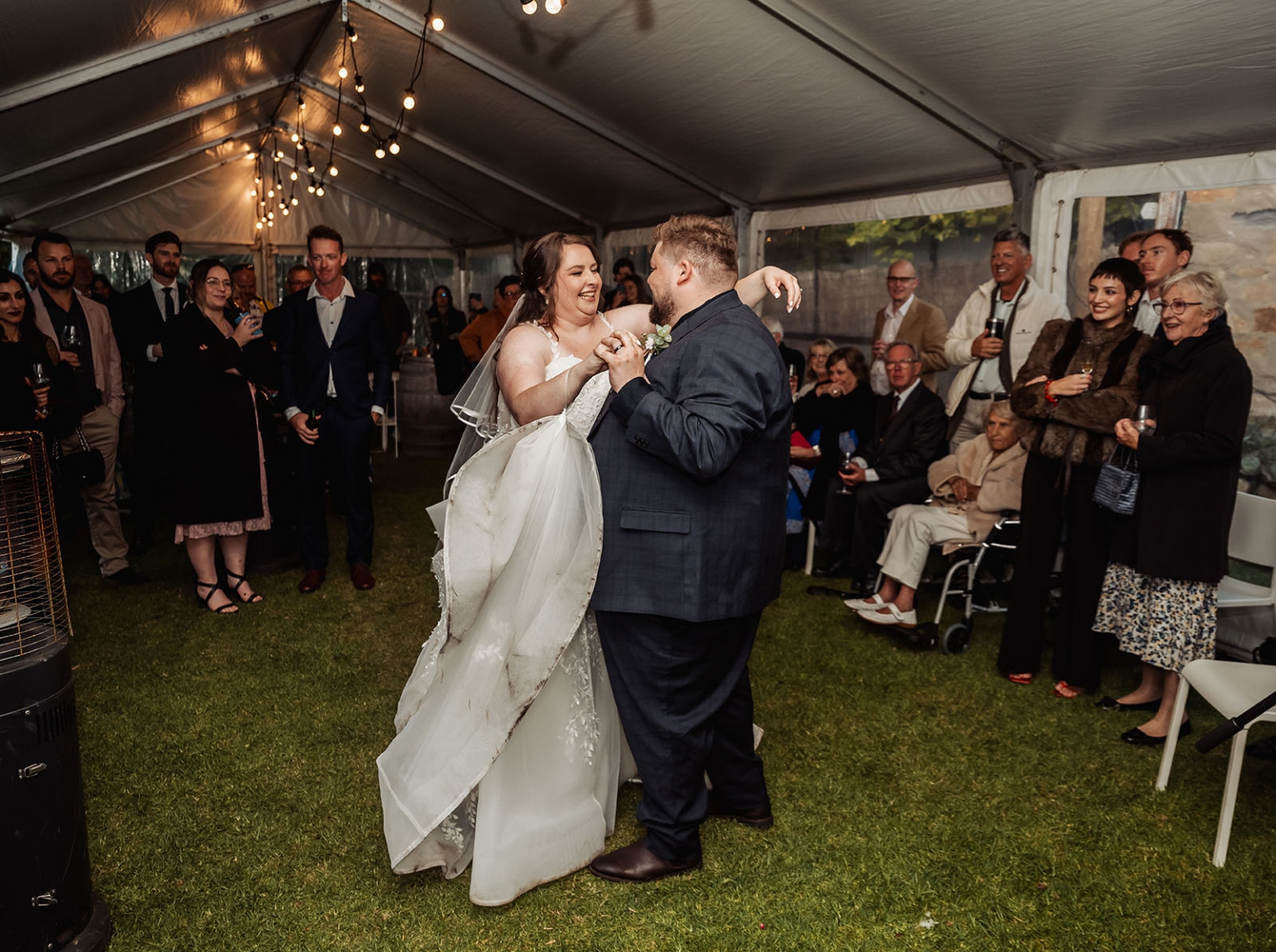 comida wedding - georgia & james 48 Bride and groom dancing joyfully at outdoor tent wedding reception.