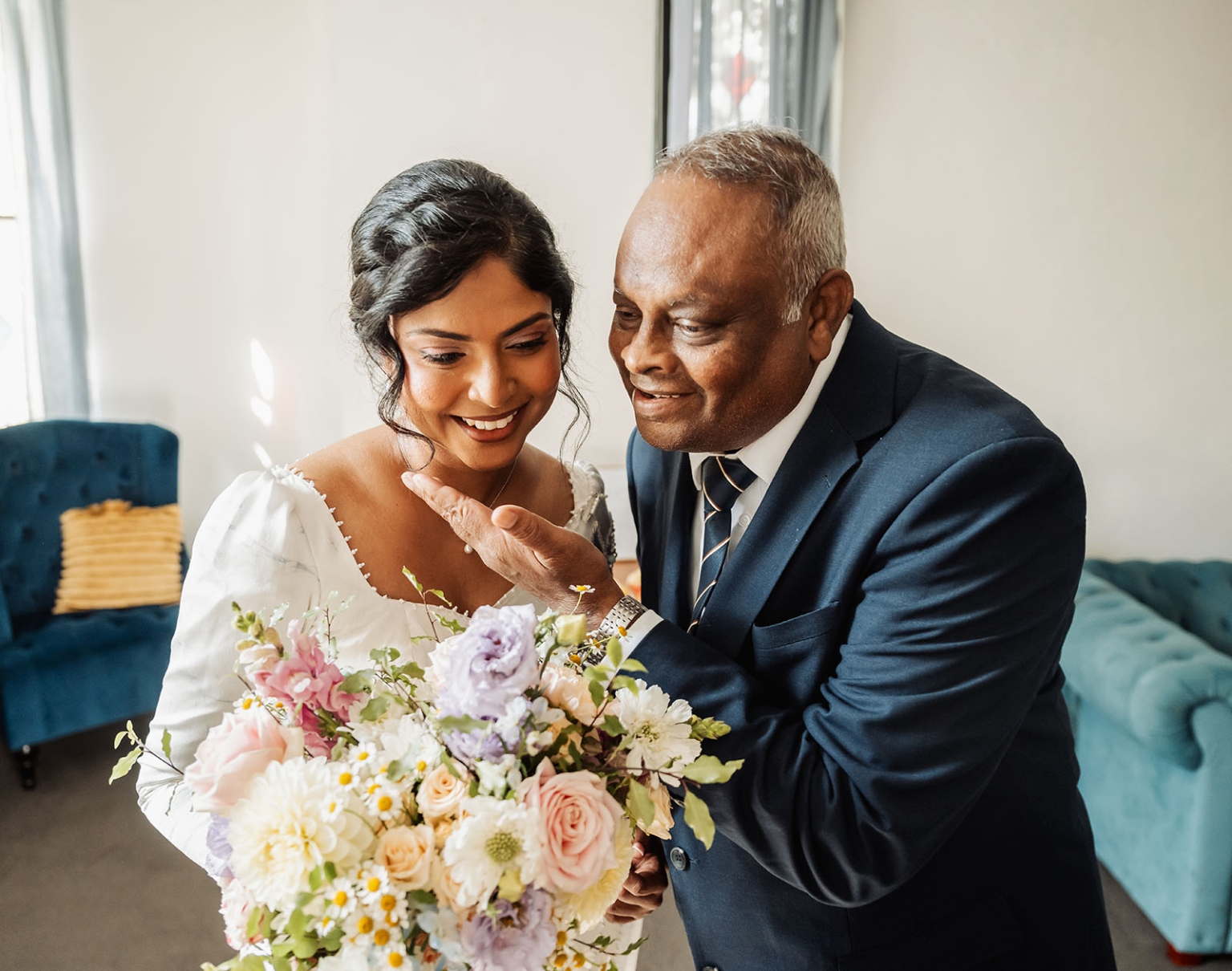 manor wedding in basket range - methmini & aravinda 121 Bride and father share a tender moment in elegant indoor wedding setting.