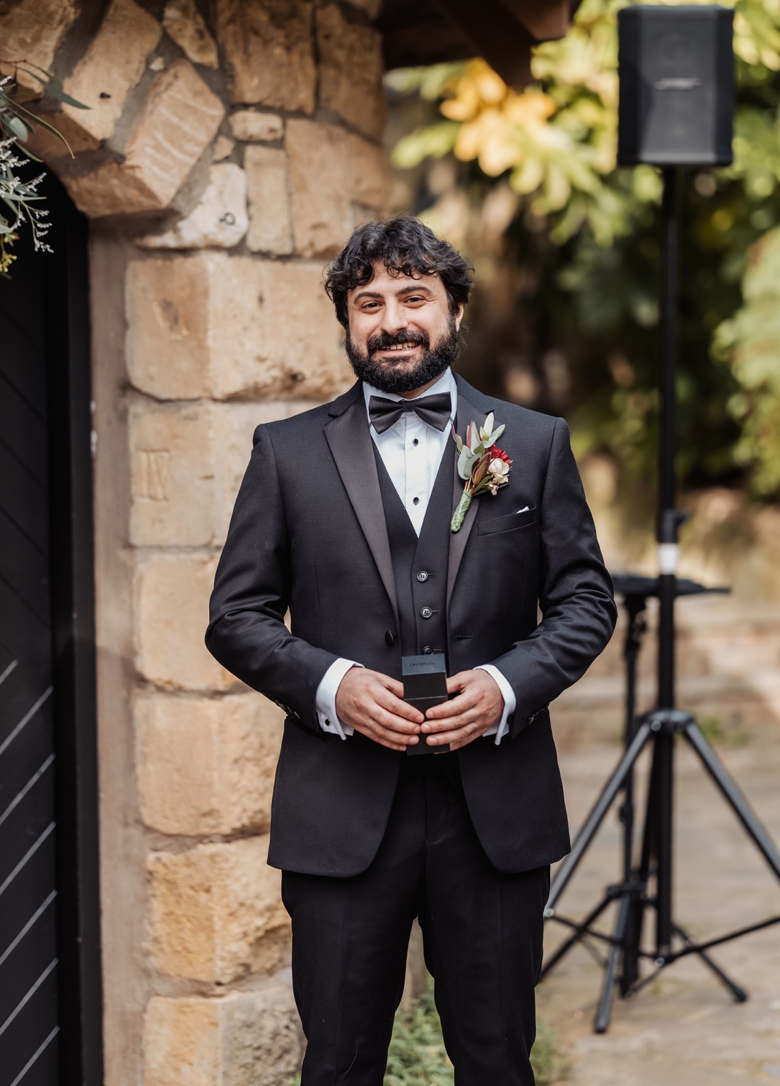 beautiful manor basket range wedding - sophie & theodore 98 Groom in tuxedo holding ring box at outdoor wedding.