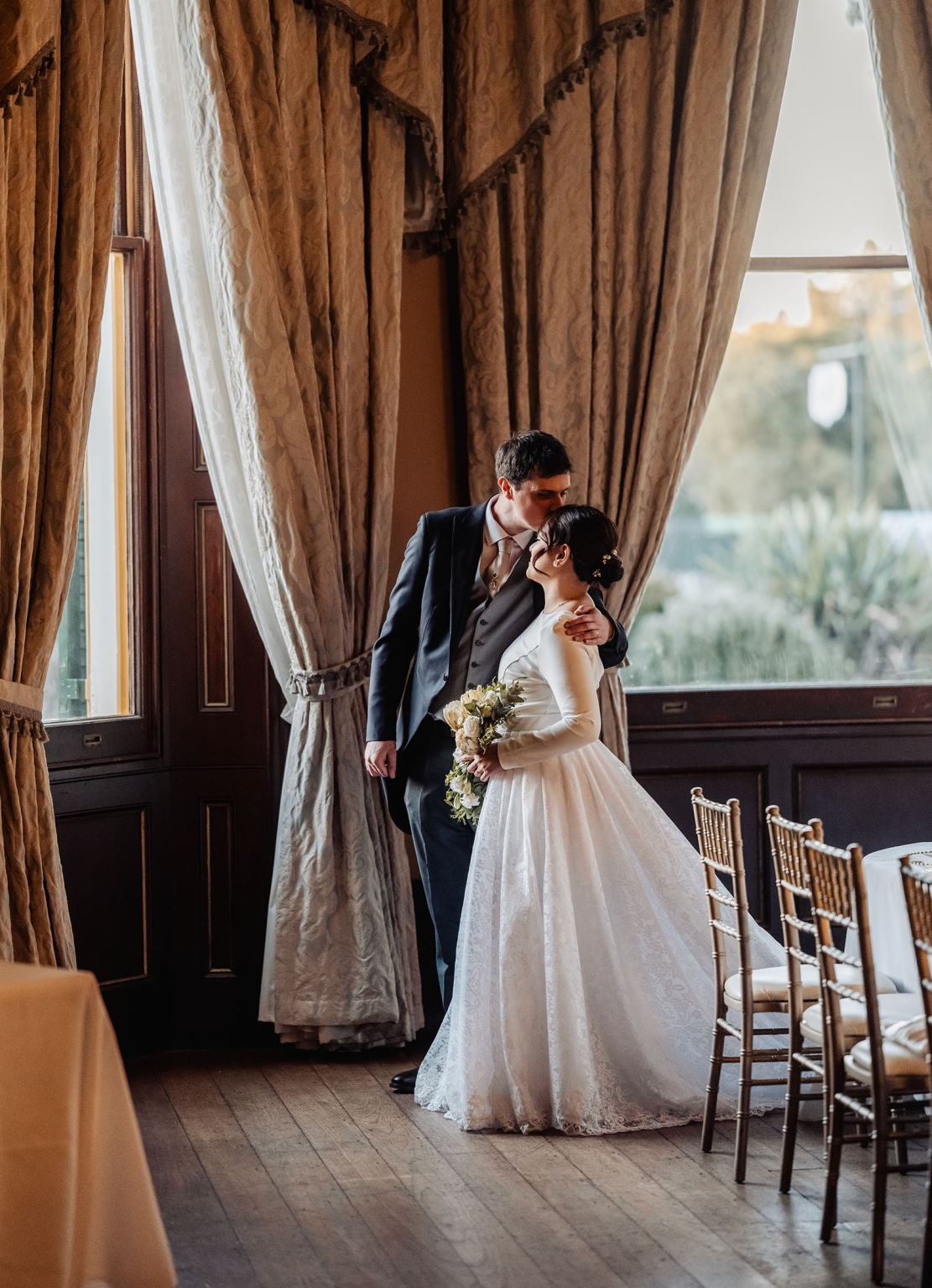 adelaide's st peter's cathedral wedding - irish & nick 41 Romantic bride and groom wedding portrait by elegant historic window.