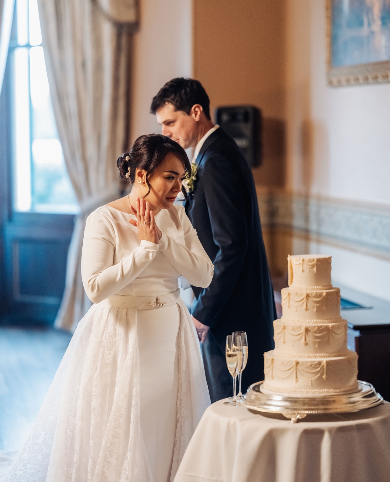 adelaide's st peter's cathedral wedding - irish & nick 53 Elegant bride and groom at wedding reception with tiered cake and champagne.