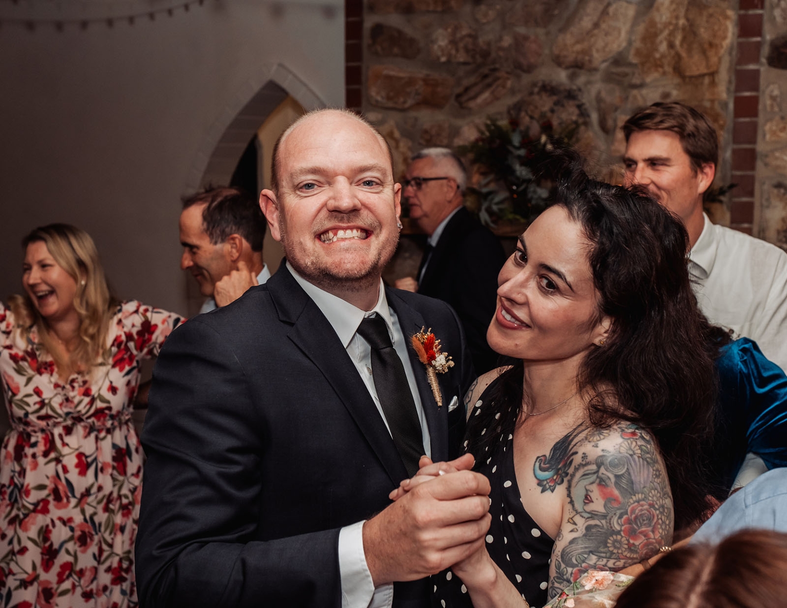 adelaide hills wedding at the manor - jo & dan 73 Joyful wedding reception guests dancing and smiling in rustic stone venue.