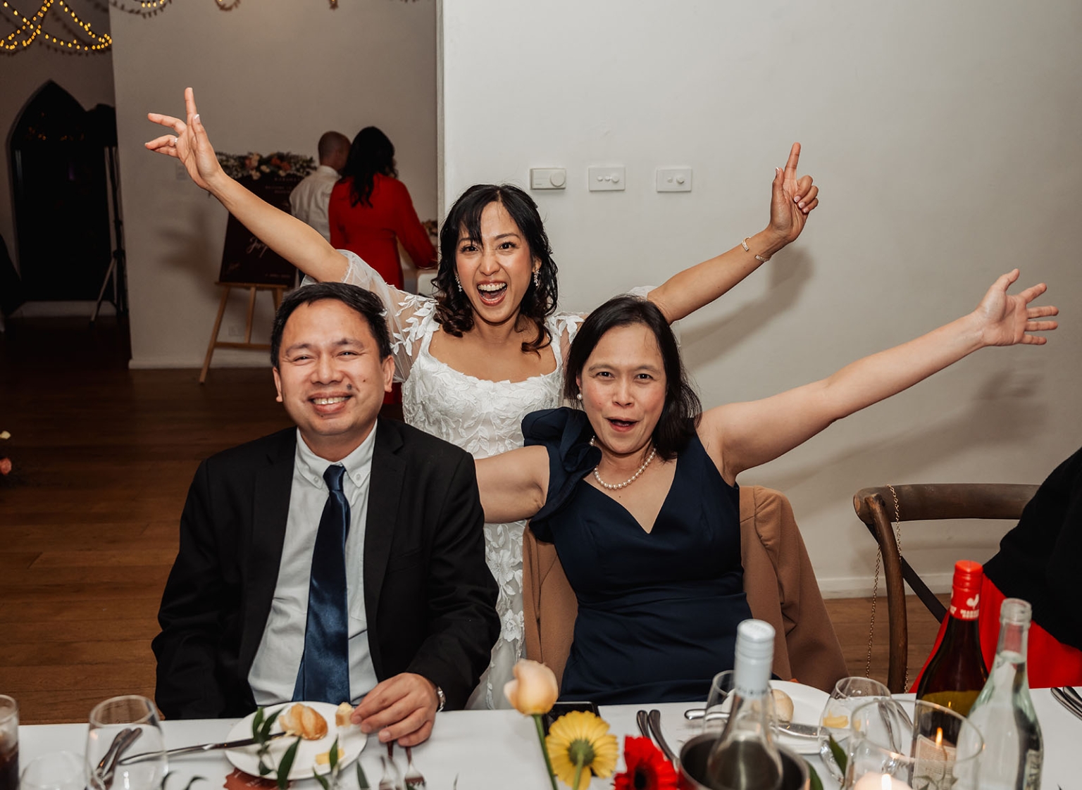 adelaide hills wedding at the manor - jo & dan 62 Joyful wedding reception guests celebrating at an elegant banquet table.