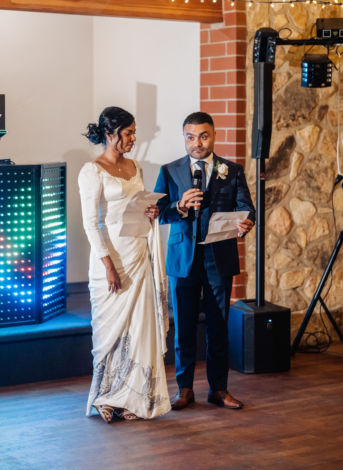 manor wedding in basket range - methmini & aravinda 167 Couple reading vows at wedding, elegant attire, romantic setting, intimate celebration.