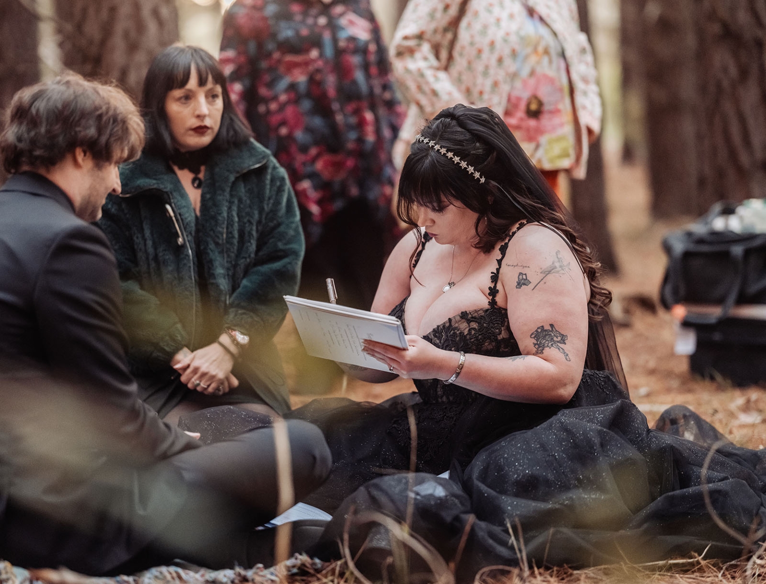 kuitpo forest metal themed wedding – erin & michael 15 Gothic woodland wedding ceremony with bride signing vows in black dress.