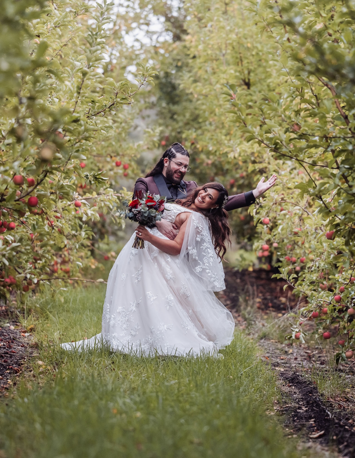 basket range wedding at the manor - leah & wes 55 Apple orchard wedding portrait of joyful bride and groom with bouquet.